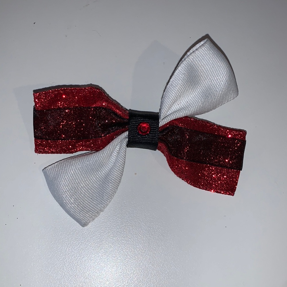 Red sparkly and white hair bow with black accents